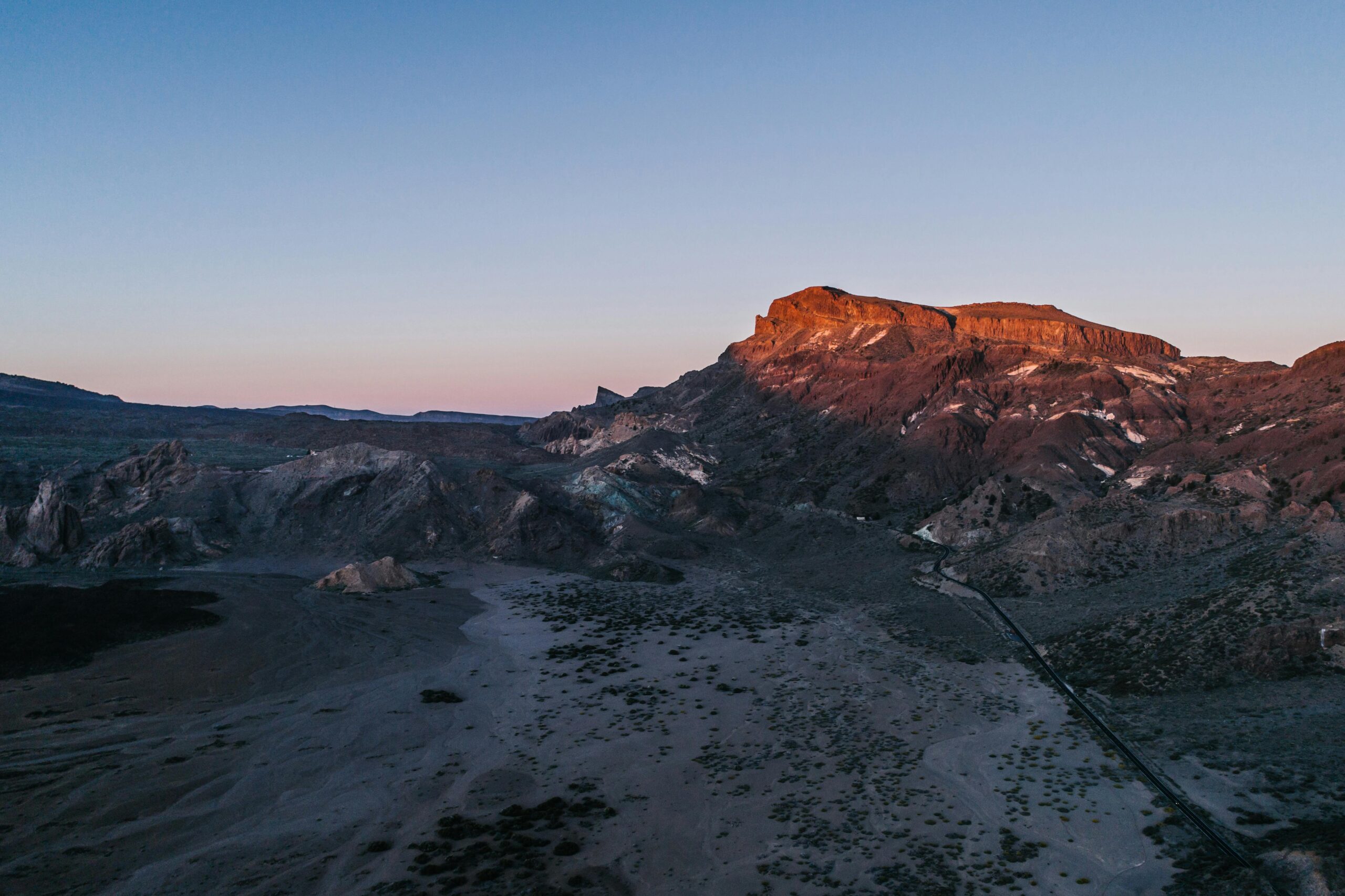 pexels-photo-8356482-8356482 A stunning aerial view of a mountain landscape at sunset, showcasing natural beauty.