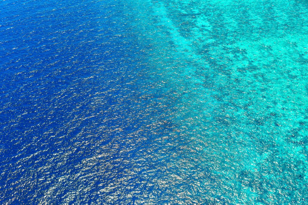 Stunning aerial view capturing the vibrant blue ocean waters of Central Kalimantan, Indonesia.
