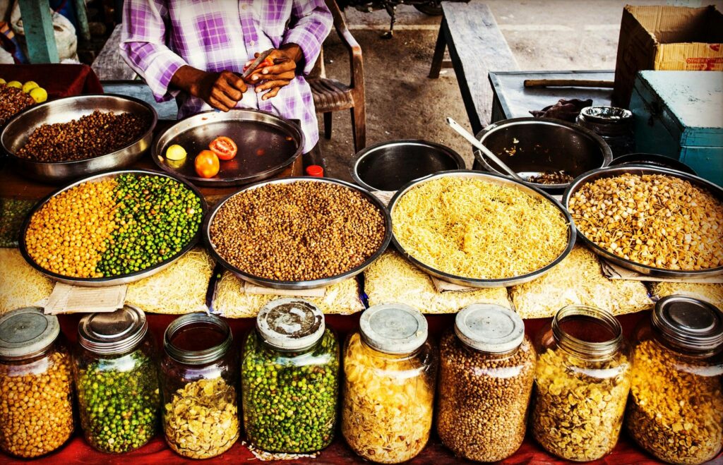 Colorful display of spices and legumes in a traditional Indian street market.
